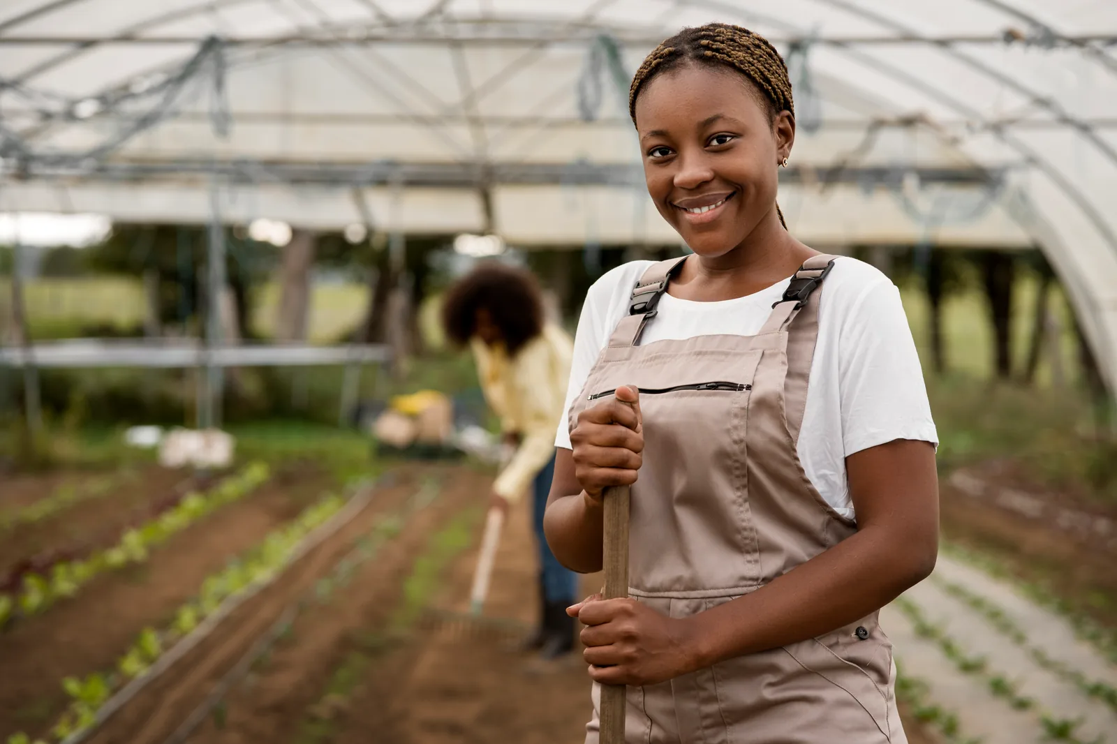An agricultural entrepreneur working in a modern greenhouse.